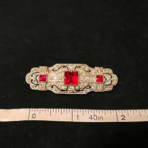 Vintage rhinestone brooch with stunning red accent stones.